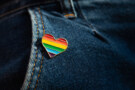 Rainbow colour LGBTQA heart badge on jeans.
