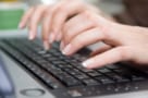 photo of fingers typing on keyboard